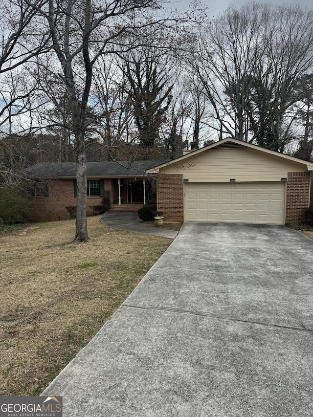 2791 Biscayne Dr, Conyers, GA 30012 - view of front facade with a front lawn, driveway, a garage, and brick siding