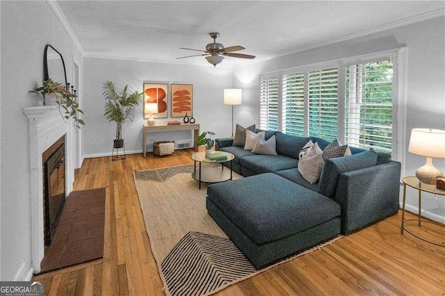 656 Channing Dr NW, Atlanta, GA 30318 - living room featuring ceiling fan, crown molding, wood finished floors, and a fireplace with flush hearth