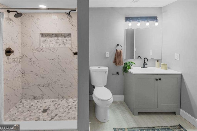 656 Channing Dr NW, Atlanta, GA 30318 - bathroom featuring vanity, a shower stall, and wood finished floors