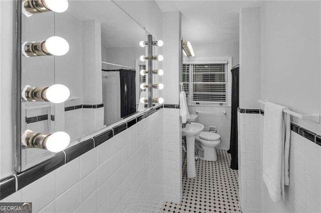 656 Channing Dr NW, Atlanta, GA 30318 - full bath featuring tile walls, tile patterned flooring, a shower with shower curtain, and a wainscoted wall