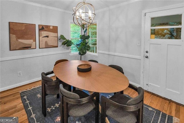 656 Channing Dr NW, Atlanta, GA 30318 - dining space with a chandelier, crown molding, and wood finished floors