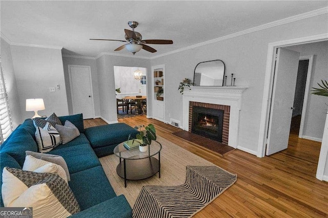 656 Channing Dr NW, Atlanta, GA 30318 - living area with wood finished floors, a ceiling fan, crown molding, and a fireplace
