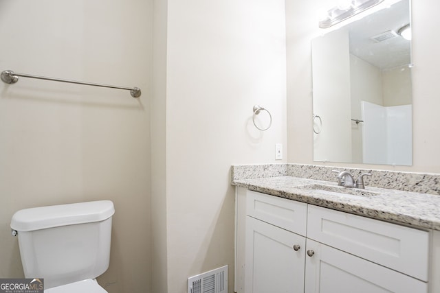 bathroom with visible vents, toilet, and vanity