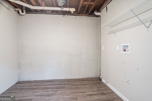clothes washing area featuring wood finished floors, laundry area, and washer hookup