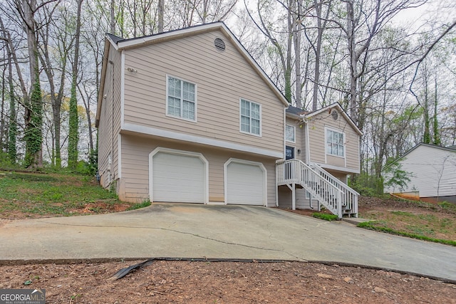 view of front of property with a garage and concrete driveway