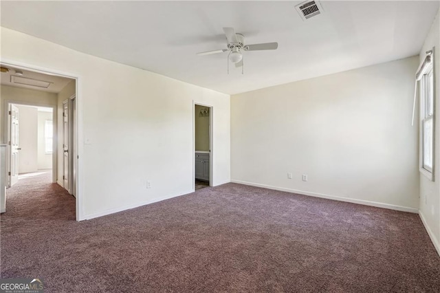 unfurnished bedroom with baseboards, carpet flooring, visible vents, and multiple windows