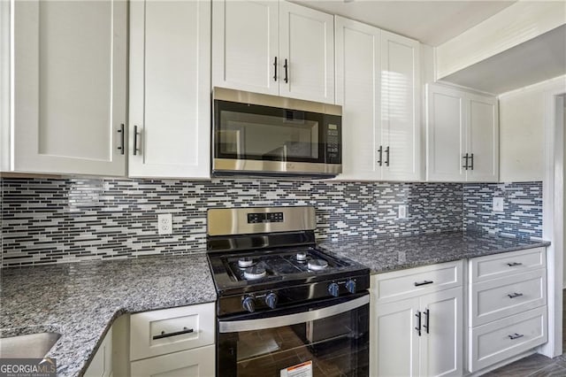 kitchen featuring white cabinets, backsplash, and stainless steel appliances