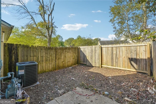 view of yard with central AC unit and a fenced backyard