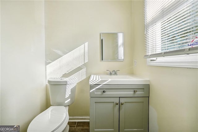 half bath featuring toilet and vanity