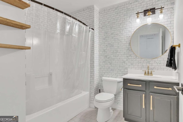 bathroom with tile patterned floors, toilet, vanity, shower / bath combo with shower curtain, and tile walls