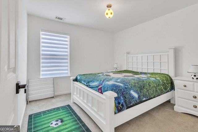 bedroom with carpet floors, baseboards, and visible vents