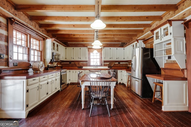 1621 Daniells Bridge Rd, Athens, GA 30606 - kitchen with stainless steel appliances, dark wood-style floors, wood counters, beam ceiling, and glass insert cabinets