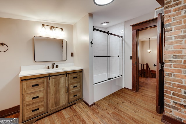 1621 Daniells Bridge Rd, Athens, GA 30606 - bathroom with wood finished floors, vanity, shower / bath combination with glass door, and baseboards