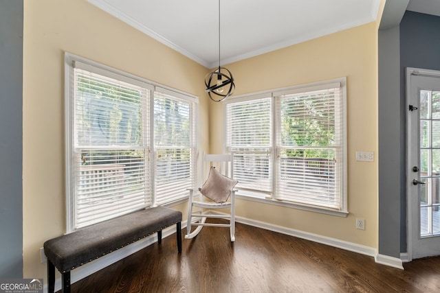 sitting room with wood finished floors, crown molding, and baseboards