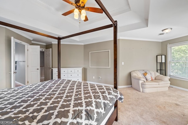 bedroom with a tray ceiling, visible vents, crown molding, baseboards, and carpet flooring