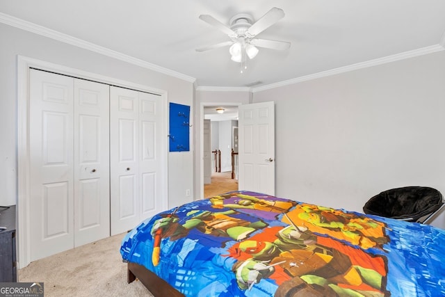 carpeted bedroom featuring a closet, crown molding, and ceiling fan