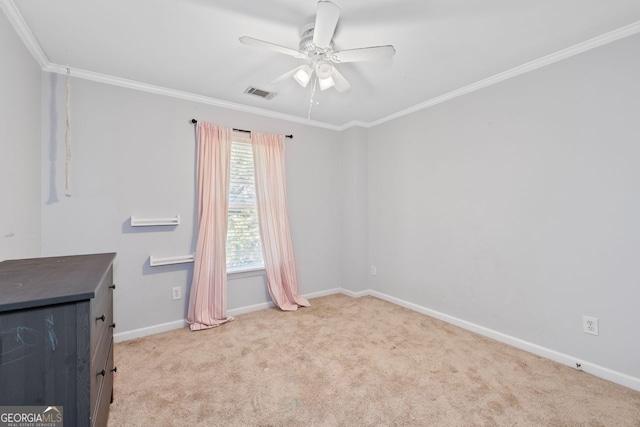 unfurnished room featuring baseboards, visible vents, ceiling fan, carpet floors, and ornamental molding