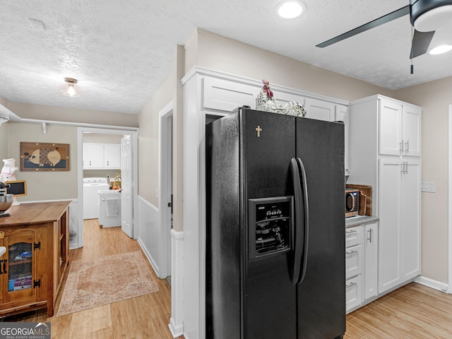 kitchen with black refrigerator with ice dispenser, light wood finished floors, white cabinets, a textured ceiling, and light countertops