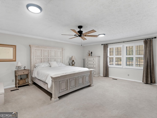 bedroom featuring crown molding, light carpet, baseboards, ceiling fan, and a textured ceiling