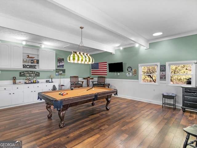 recreation room with dark wood-style floors, beamed ceiling, a wainscoted wall, crown molding, and pool table