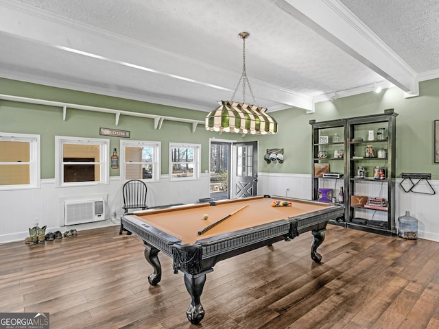 rec room featuring a textured ceiling, hardwood / wood-style floors, a wainscoted wall, beamed ceiling, and crown molding