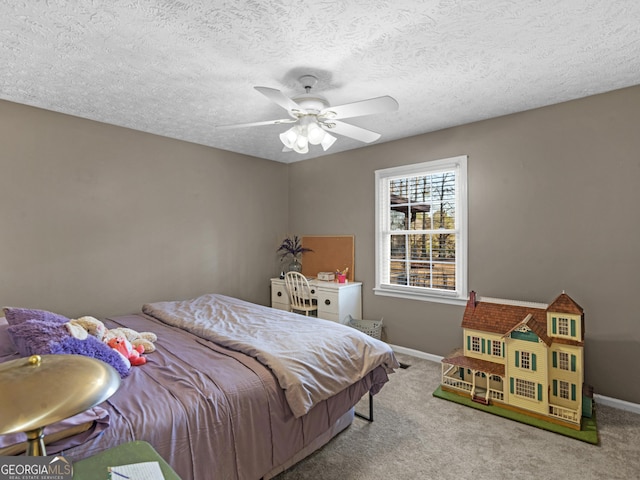 bedroom featuring carpet, baseboards, a ceiling fan, and a textured ceiling