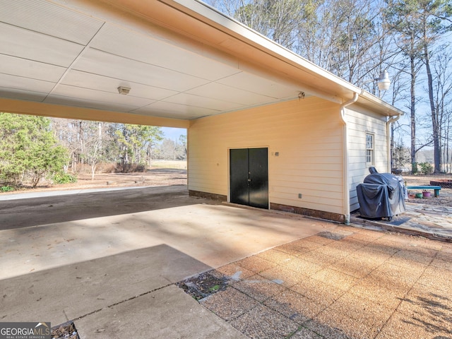 view of patio / terrace featuring a grill and a carport