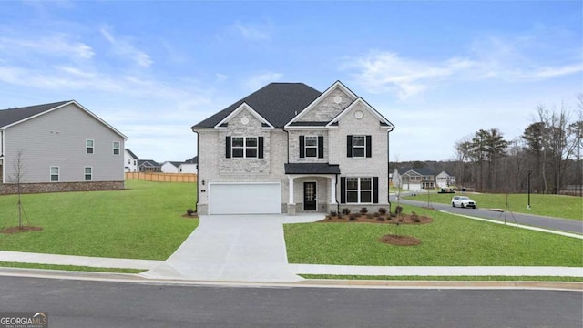 1099 Blue Juniper Cir, Loganville, GA 30052 - view of front of property featuring stone siding, concrete driveway, fence, an attached garage, and a front lawn
