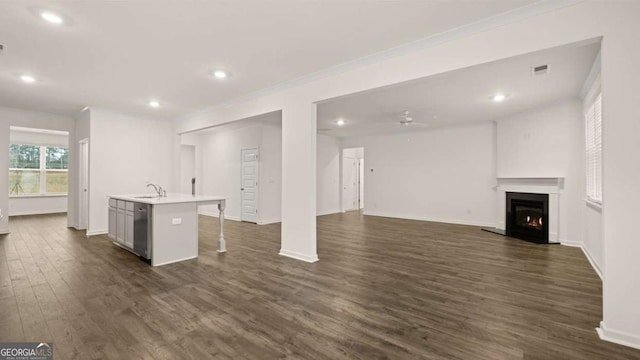 1099 Blue Juniper Cir, Loganville, GA 30052 - interior space with crown molding, baseboards, a ceiling fan, a lit fireplace, and dark wood-style floors