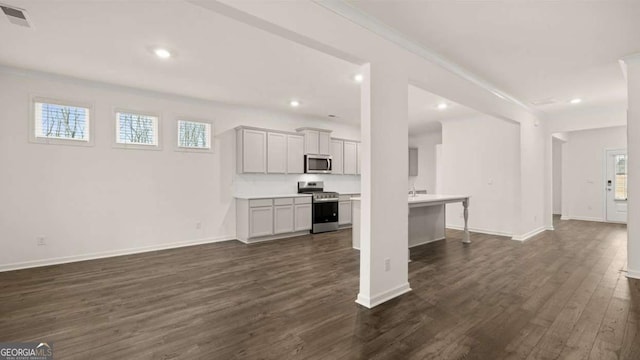 1099 Blue Juniper Cir, Loganville, GA 30052 - unfurnished living room with recessed lighting, baseboards, and dark wood finished floors