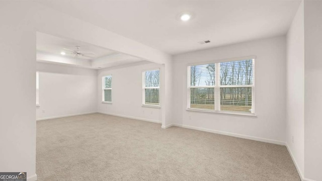1099 Blue Juniper Cir, Loganville, GA 30052 - carpeted spare room with visible vents, baseboards, ceiling fan, recessed lighting, and a tray ceiling