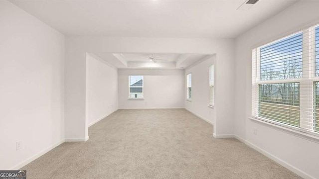 1099 Blue Juniper Cir, Loganville, GA 30052 - carpeted spare room with baseboards, ceiling fan, visible vents, and a raised ceiling