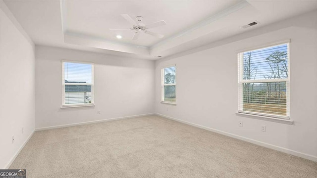 1099 Blue Juniper Cir, Loganville, GA 30052 - carpeted empty room with baseboards, visible vents, a ceiling fan, and a raised ceiling