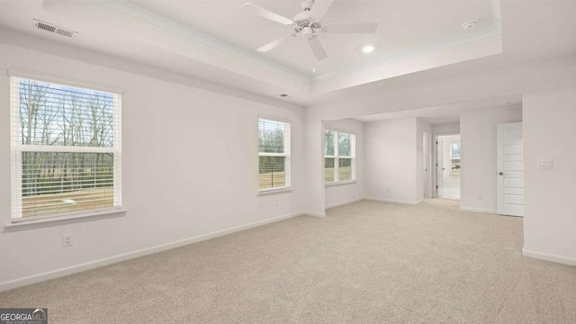 1099 Blue Juniper Cir, Loganville, GA 30052 - spare room with baseboards, a tray ceiling, visible vents, and light carpet