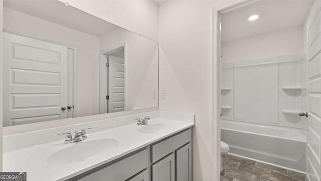 1099 Blue Juniper Cir, Loganville, GA 30052 - full bath featuring double vanity, toilet, stone finish flooring, and a sink