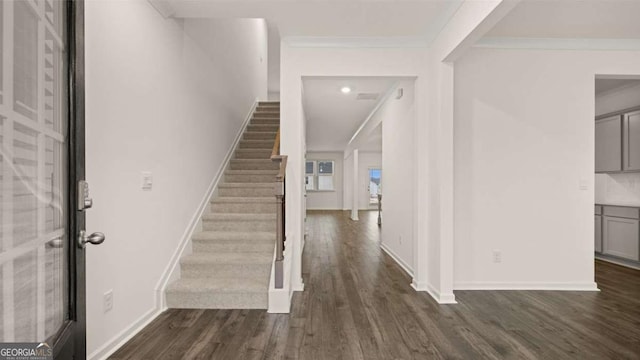 1099 Blue Juniper Cir, Loganville, GA 30052 - foyer with dark wood-style floors, crown molding, and stairs