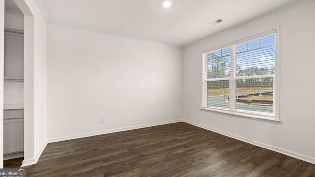 1099 Blue Juniper Cir, Loganville, GA 30052 - unfurnished room featuring baseboards, ornamental molding, visible vents, and dark wood finished floors