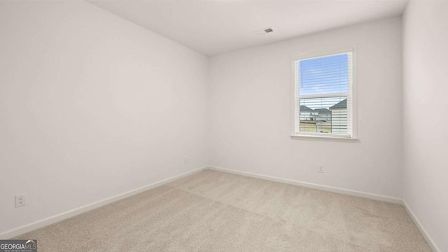 1099 Blue Juniper Cir, Loganville, GA 30052 - spare room with baseboards, light colored carpet, and visible vents