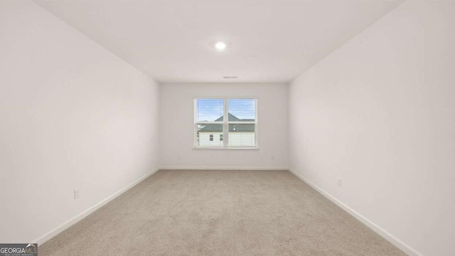 1099 Blue Juniper Cir, Loganville, GA 30052 - spare room with light carpet and baseboards