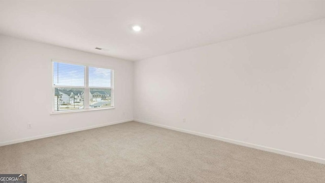 1099 Blue Juniper Cir, Loganville, GA 30052 - unfurnished room with light colored carpet and baseboards