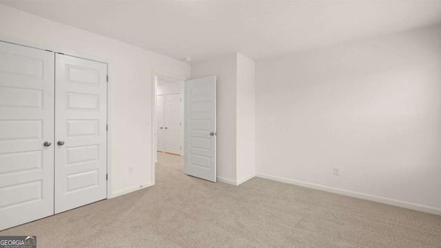 1099 Blue Juniper Cir, Loganville, GA 30052 - unfurnished bedroom with baseboards, carpet flooring, and a closet
