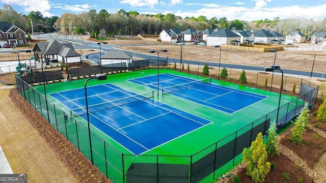 1099 Blue Juniper Cir, Loganville, GA 30052 - view of tennis court with fence and a residential view