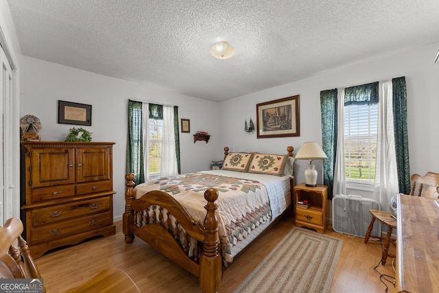 1595 Historic Old Highway 441, Clarkesville, GA 30523 - bedroom with light wood-style flooring and a textured ceiling
