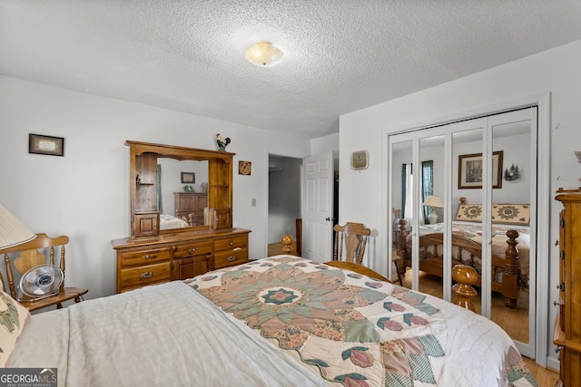 1595 Historic Old Highway 441, Clarkesville, GA 30523 - bedroom featuring a textured ceiling, a closet, and wood finished floors
