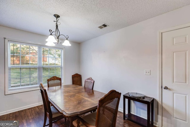 8166 N Pine Cone Dr, Villa Rica, GA 30180 - dining area with dark wood-style flooring, baseboards, a textured ceiling, visible vents, and a notable chandelier