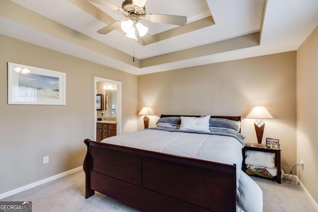 8166 N Pine Cone Dr, Villa Rica, GA 30180 - bedroom with ensuite bath, light carpet, a tray ceiling, and baseboards