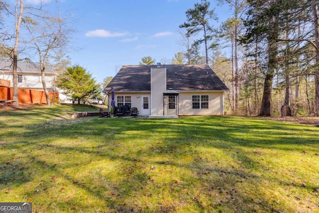 8166 N Pine Cone Dr, Villa Rica, GA 30180 - back of property featuring a patio, a yard, and a chimney