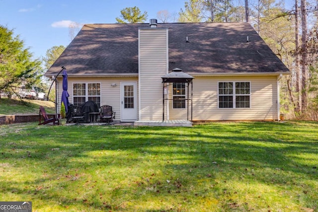 8166 N Pine Cone Dr, Villa Rica, GA 30180 - rear view of property featuring a chimney, a gazebo, a patio area, and a lawn
