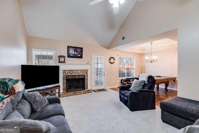 8166 N Pine Cone Dr, Villa Rica, GA 30180 - living area with visible vents, baseboards, a fireplace, ceiling fan with notable chandelier, and a tray ceiling