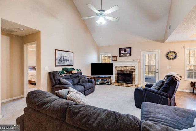 8166 N Pine Cone Dr, Villa Rica, GA 30180 - carpeted living room with baseboards, a fireplace, high vaulted ceiling, and ceiling fan